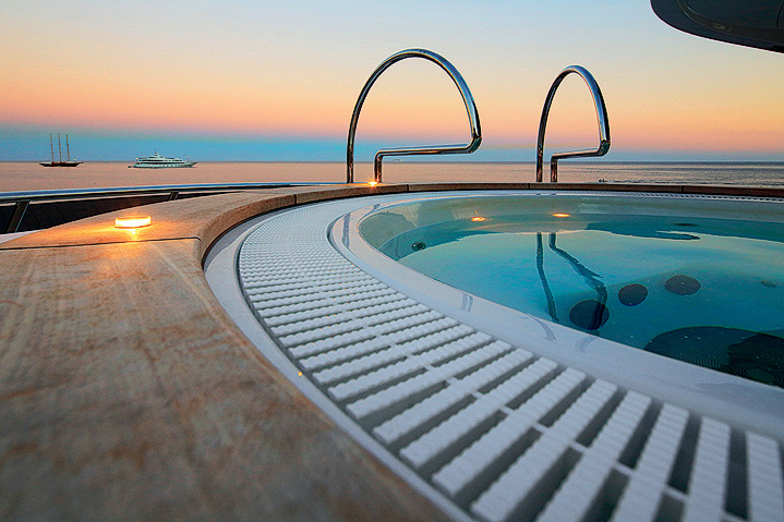 The hot tub is located on the upper deck.