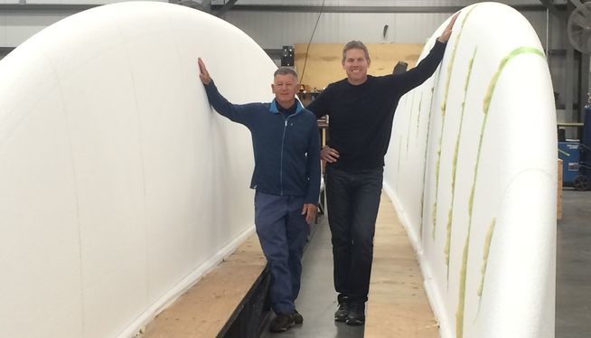 Bob Steele and John Barnitt are posing between the two halves of the future surfboard record holder.
