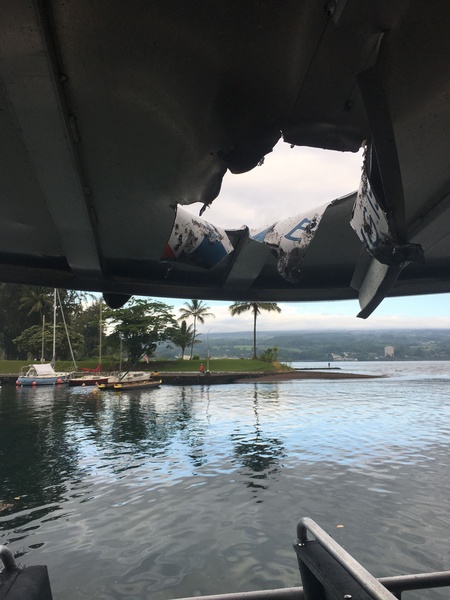 A hole in the roof of a tourist boat left by a lava bomb.