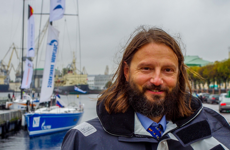 Vladimir Lyubomirov, Commander of the St. Petersburg Yacht Club, on the background of the Battleship.