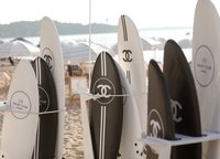 Almost everything here is decorated exclusively in branded black and white colors - umbrellas from the scorching sun, lifeguards for careless swimmers, branded surf boards for «riding» waves, rackets - badminton tools - and further on the list.