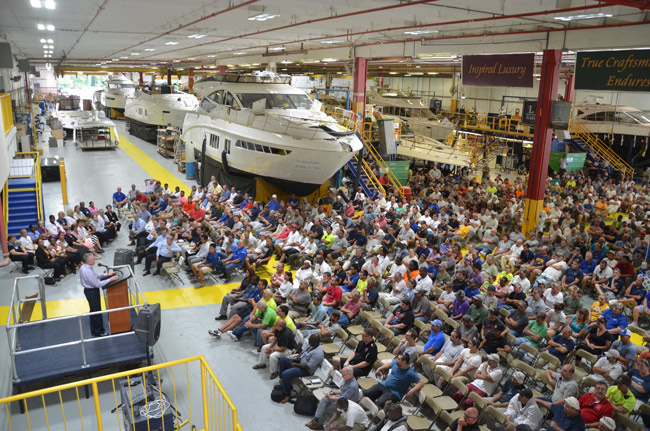 Workers at Sea Ray's Palm Coast factory listen to the news of the upcoming reorganization.