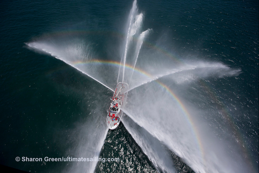 «I bless you on all four sides!» It seems that these very colorful lines as if quote the escort ship to the participants of the regatta, having arranged for them a water fireworks and causing a bright rainbow. In the end, even the most experienced skipper at sea will never hurt a little luck.
