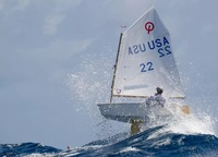 American Tommy Sitzmann confronts waves at his «Optimist» Regatta during the St Thomas International Optimist Regatta in the Virgin Islands in the Caribbean Sea.
