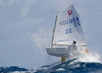 American Tommy Sitzmann confronts waves at his «Optimist» Regatta during the St Thomas International Optimist Regatta in the Virgin Islands in the Caribbean Sea.