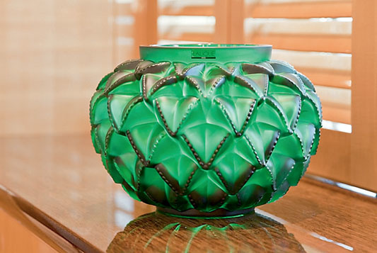 Lalique emerald vase attracts the views of the main salon guests.