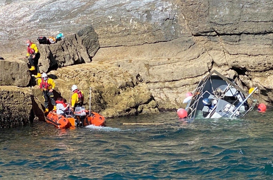 A man put a boat on the rocks to save his family.
