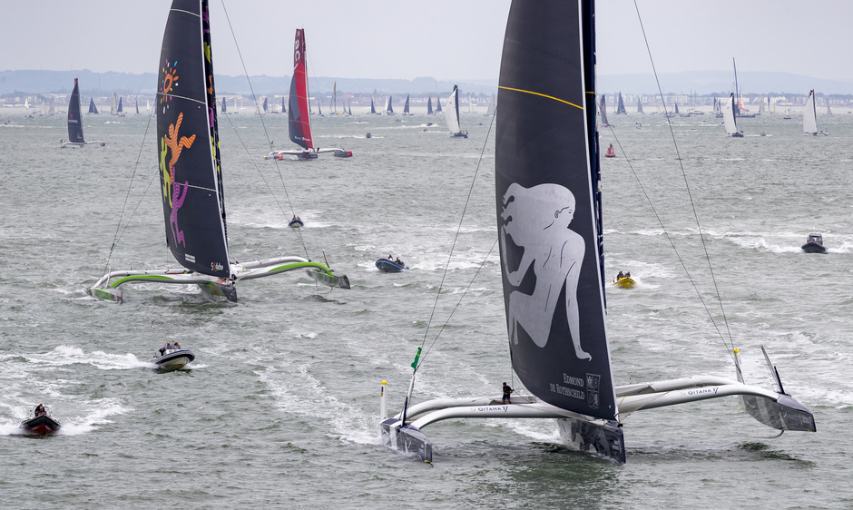 French trimaran Maxi Edmond De Rothschild leads a fleet of multihulls at the start of the regatta.