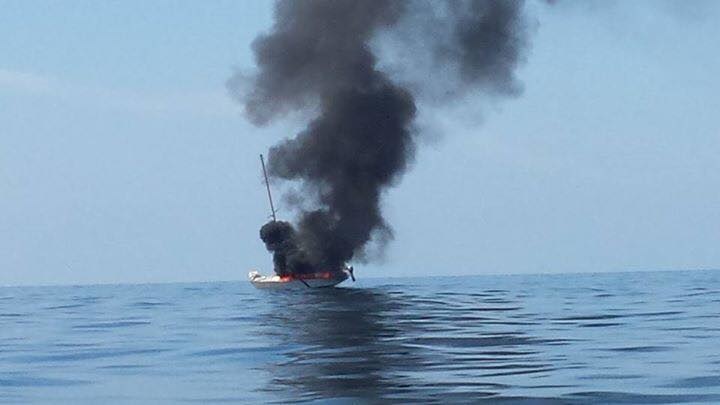 Sitting in a boat, John Kanafoski took off his blazing property